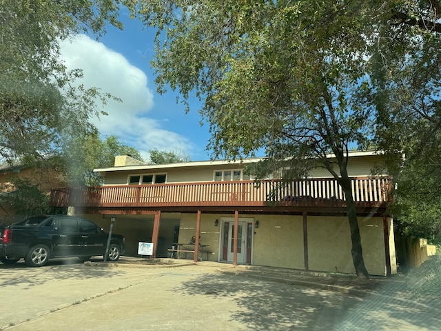 rear view of house with a wooden deck