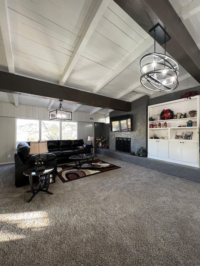 living room featuring an inviting chandelier, beam ceiling, and carpet