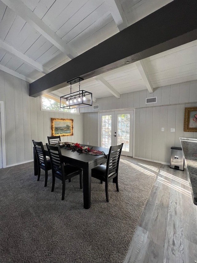 dining room with hardwood / wood-style flooring and beam ceiling