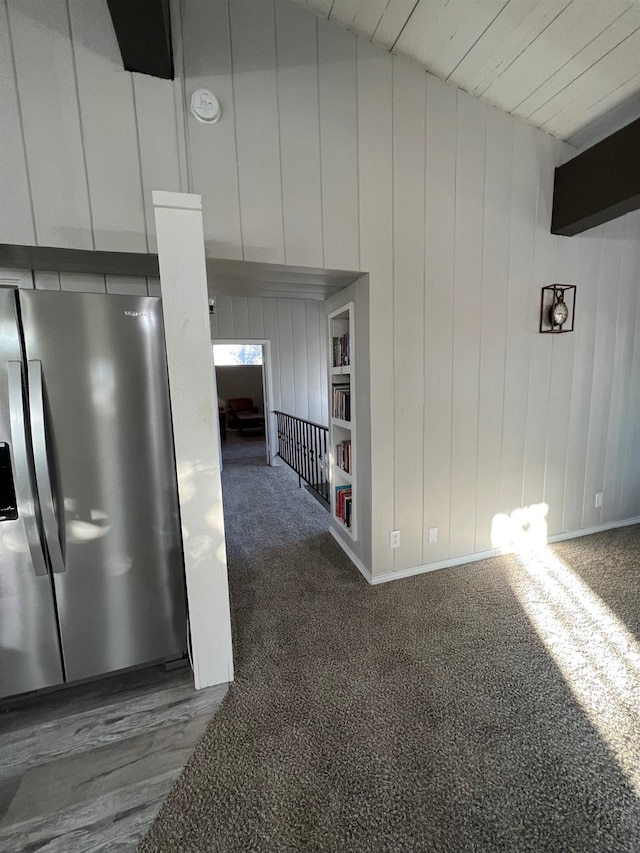 hall with dark colored carpet