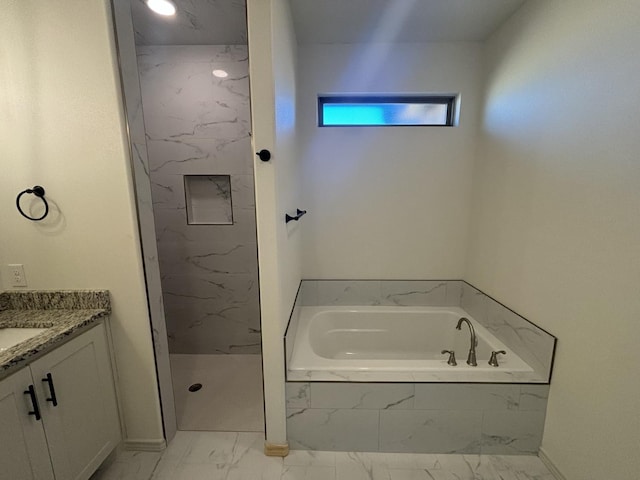 bathroom with vanity and shower with separate bathtub