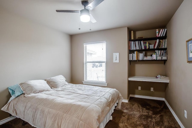 carpeted bedroom featuring baseboards and ceiling fan
