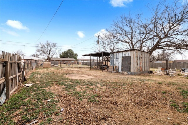 view of yard with a storage unit, an outdoor structure, and fence