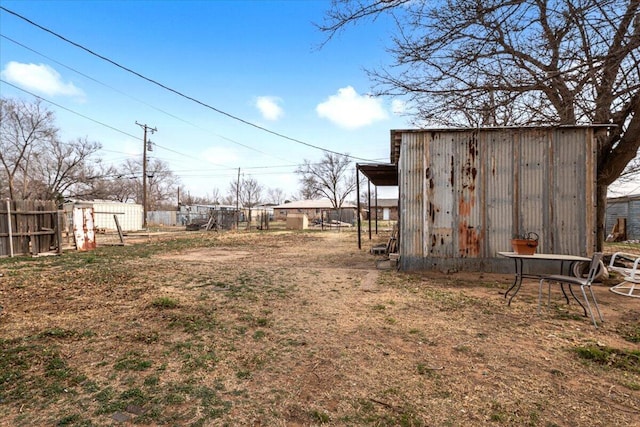 view of yard with an outdoor structure and fence