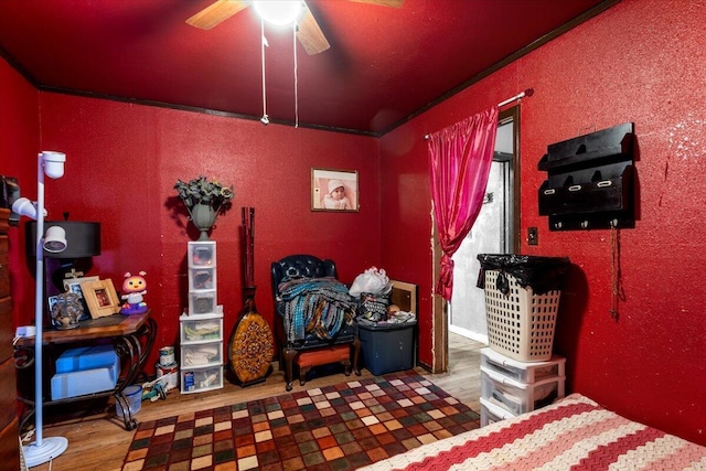bedroom with ceiling fan and wood finished floors