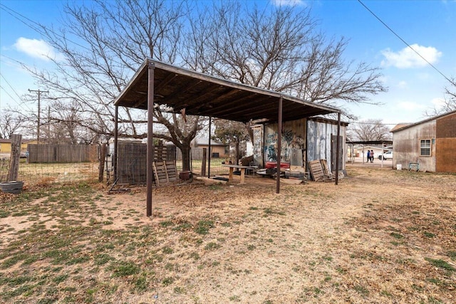 view of yard featuring an outbuilding and fence