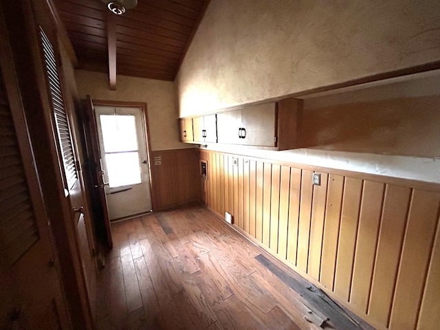 bonus room with wood-type flooring, lofted ceiling with beams, and wooden ceiling