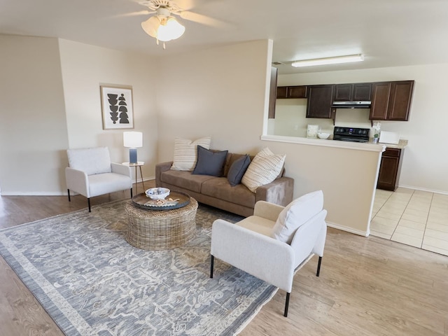 living room featuring light hardwood / wood-style floors and ceiling fan