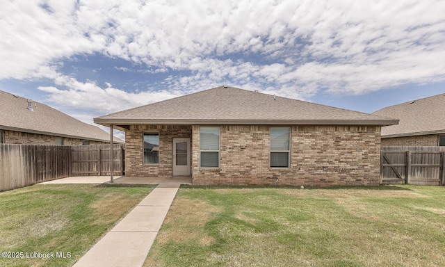 5234 Jarvis St, Lubbock, TX 79416 - back of house with a patio area, a fenced backyard, brick siding, and a shingled roof
