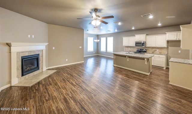 5234 Jarvis St, Lubbock, TX 79416 - kitchen featuring stainless steel appliances, a ceiling fan, dark wood-type flooring, and white cabinets