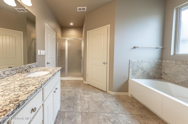 5234 Jarvis St, Lubbock, TX 79416 - full bath featuring vanity, plenty of natural light, a shower stall, a garden tub, and recessed lighting