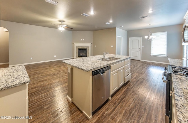 5234 Jarvis St, Lubbock, TX 79416 - kitchen with stainless steel appliances, a ceiling fan, an island with sink, a fireplace, and dark wood-style flooring