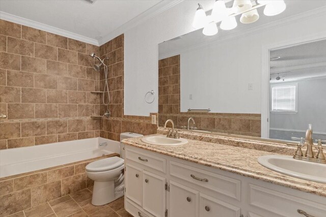 full bathroom featuring vanity, ornamental molding, tiled shower / bath, and toilet