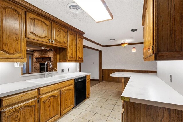 kitchen featuring sink, light tile patterned floors, black dishwasher, a textured ceiling, and decorative light fixtures