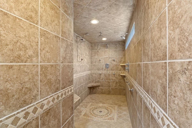 interior details featuring tiled shower