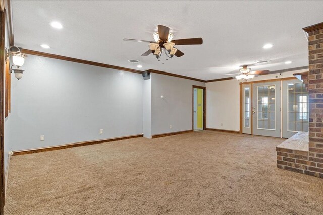 interior space with crown molding, a textured ceiling, ceiling fan, and carpet flooring