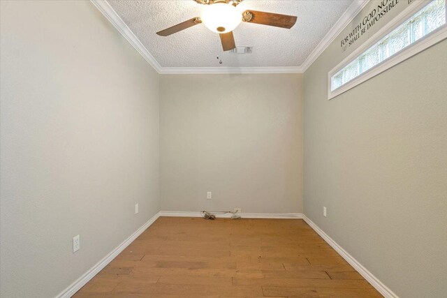 unfurnished room with crown molding, light hardwood / wood-style flooring, and a textured ceiling