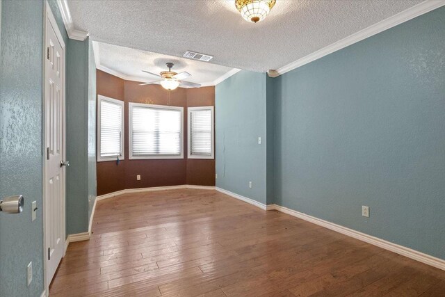 unfurnished room featuring hardwood / wood-style flooring, ceiling fan, ornamental molding, and a textured ceiling