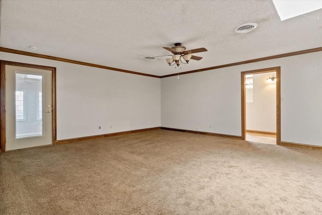 carpeted spare room with ceiling fan, ornamental molding, and a textured ceiling