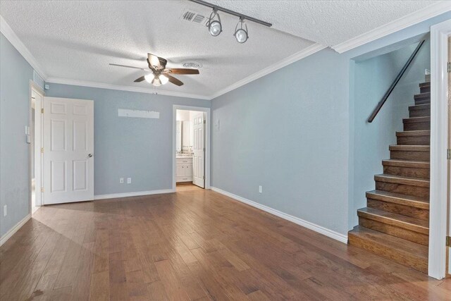 empty room featuring wood-type flooring, ornamental molding, and ceiling fan