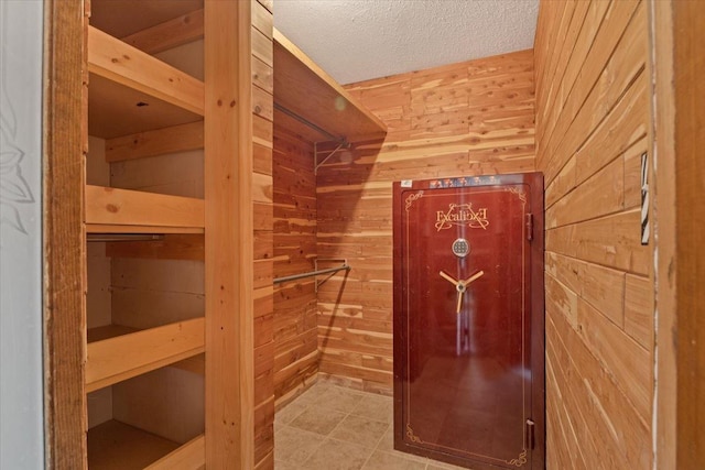 walk in closet with tile patterned floors