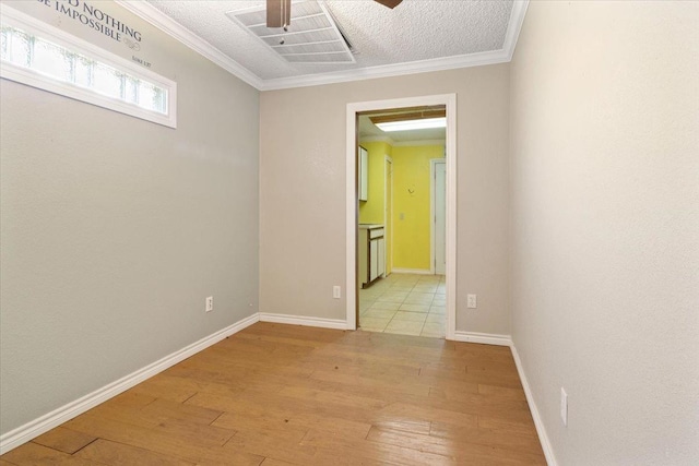 unfurnished room with ceiling fan, ornamental molding, light hardwood / wood-style floors, and a textured ceiling