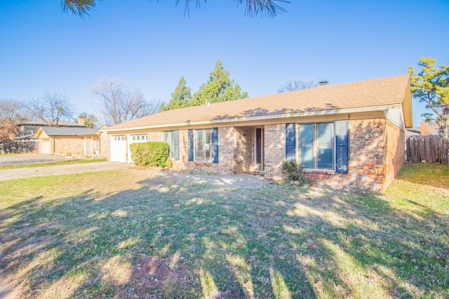 single story home featuring a garage and a front yard