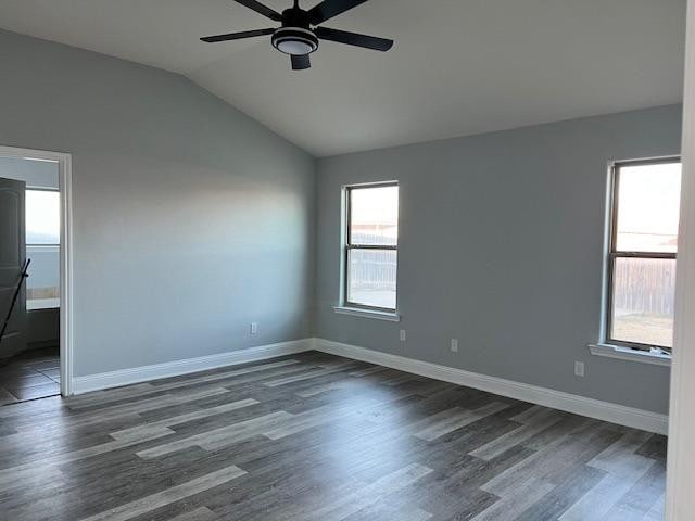 spare room with lofted ceiling, dark wood-type flooring, and ceiling fan