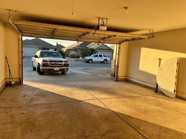 garage with a garage door opener and a carport