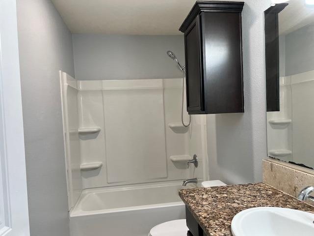 full bathroom with toilet,  shower combination, and vanity