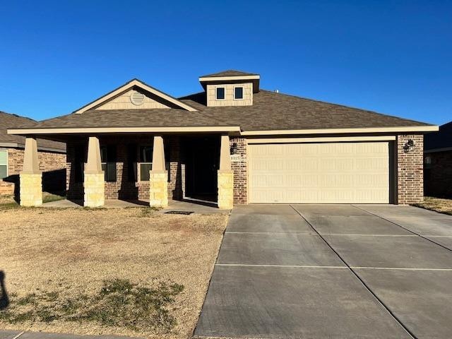 view of front facade with driveway, an attached garage, and brick siding