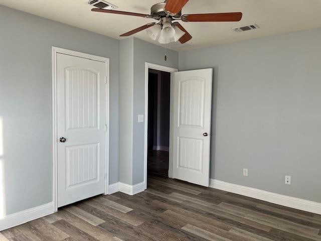 unfurnished bedroom featuring dark hardwood / wood-style floors and ceiling fan