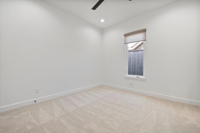 carpeted spare room featuring ceiling fan