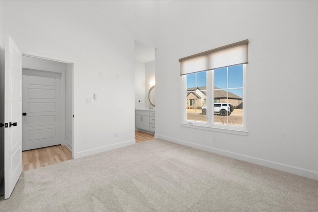 unfurnished room featuring light carpet