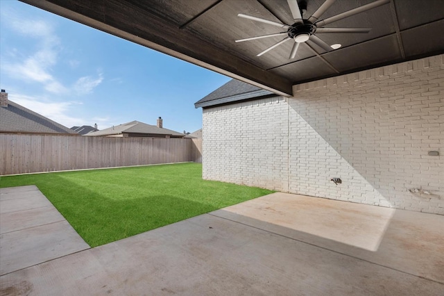 view of yard with ceiling fan and a patio