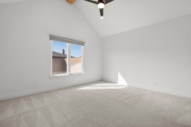 empty room with ceiling fan, light colored carpet, beam ceiling, and high vaulted ceiling