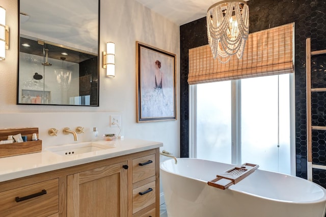 bathroom with vanity, a notable chandelier, and independent shower and bath