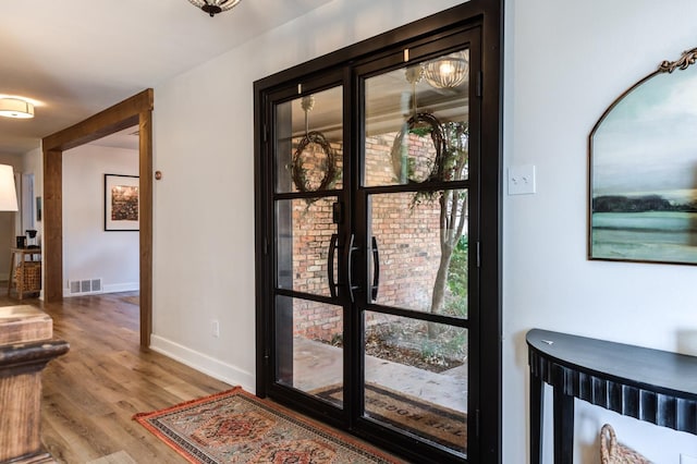 interior space with hardwood / wood-style floors and french doors