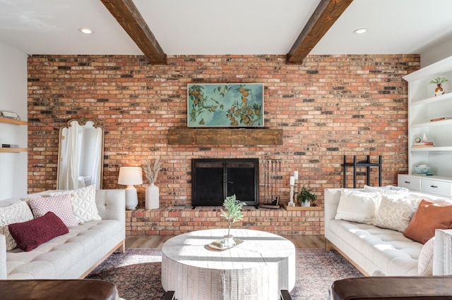 living room with a fireplace, wood-type flooring, and beamed ceiling