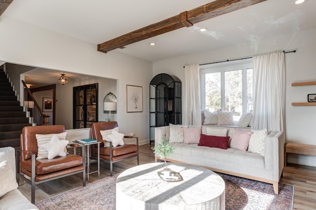 living room featuring wood-type flooring and beam ceiling