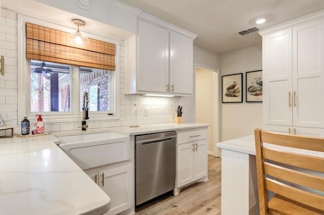 kitchen with white cabinetry, sink, pendant lighting, and dishwasher