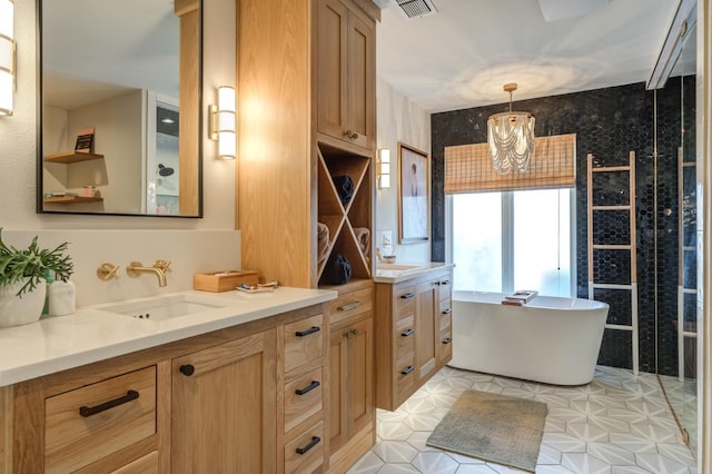 bathroom featuring a tub to relax in, vanity, and a notable chandelier