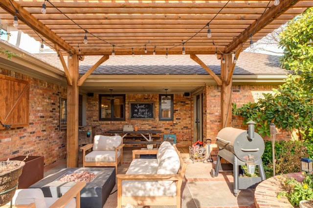 view of patio with grilling area, a pergola, and an outdoor living space with a fire pit