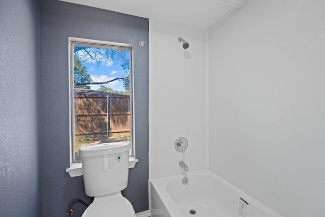 bathroom featuring toilet and shower / bath combination