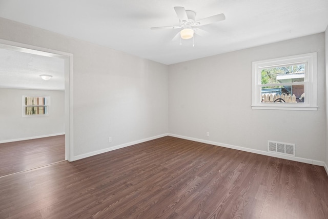 unfurnished room featuring dark hardwood / wood-style flooring and ceiling fan