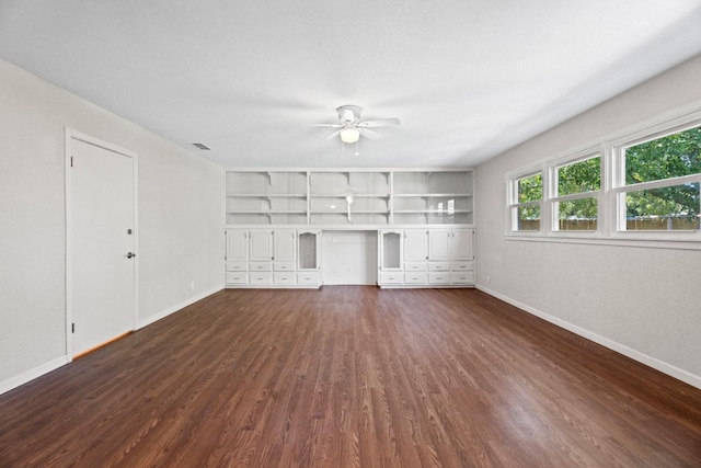 unfurnished living room with ceiling fan, dark hardwood / wood-style flooring, and built in features