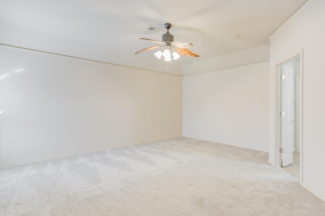 carpeted spare room with ceiling fan