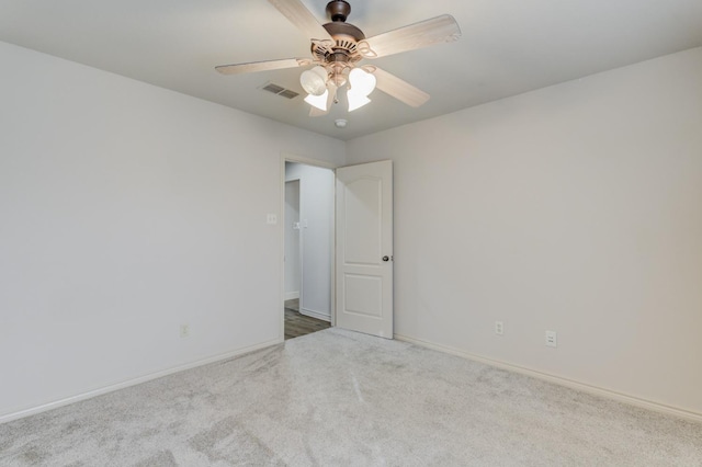 carpeted spare room with ceiling fan