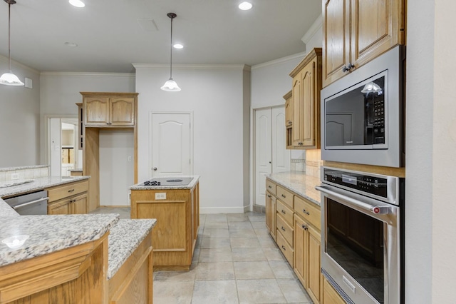 kitchen with stainless steel appliances, a kitchen island, light stone countertops, and hanging light fixtures