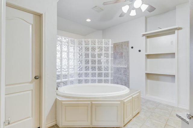 bathroom featuring ceiling fan, tile patterned floors, and a washtub